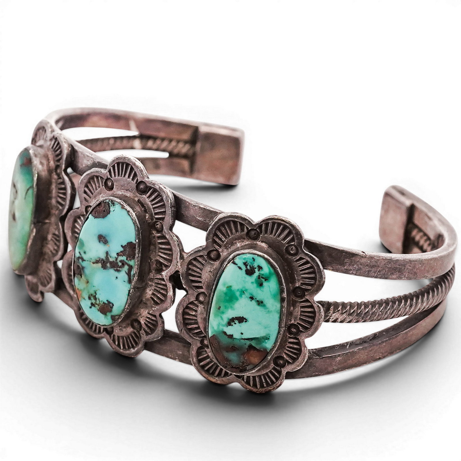 Vintage Navajo Sterling Silver & Turquoise Floral Cuff Bracelet: Vintage Navajo Sterling Silver & Turquoise Floral Cuff Bracelet 1970s-1980s, USA Sterling silver cuff set with three oval turquoise cabochons, each in plain bezels within scalloped stamped surrounds, 