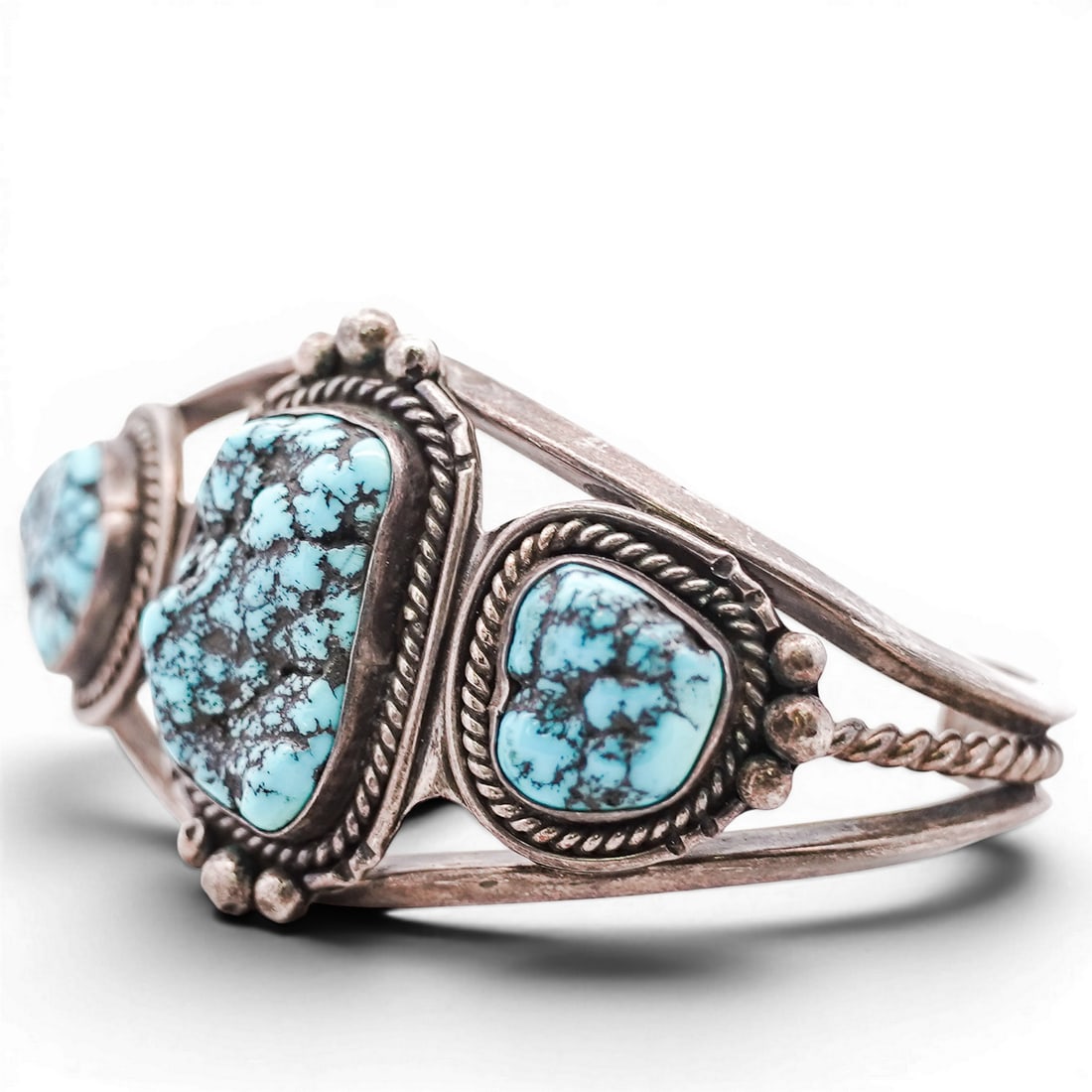 Vintage Navajo Sterling Silver & Turquoise Cuff Bracelet: Vintage Navajo Sterling Silver & Turquoise Cuff Bracelet 1970s-1980s, USA Vintage Navajo sterling silver cuff set with three irregular turquoise cabochons, the center stone framed by rope-twist and ap