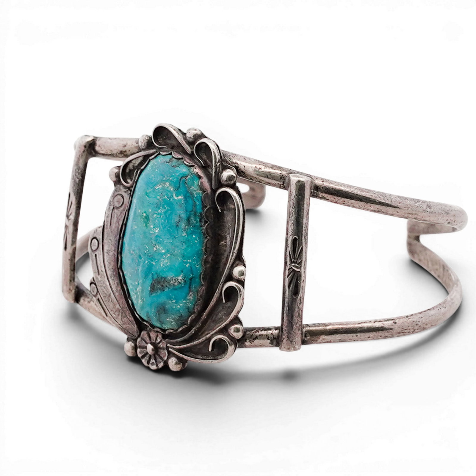Vintage Navajo Sterling Silver & Turquoise Cuff Bracelet: Vintage Navajo Sterling Silver & Turquoise Cuff Bracelet 1970s-1980s, USA Sterling silver cuff set with an oval turquoise cabochon in a sawtooth bezel, framed by applied wirework, bead accents, and sp