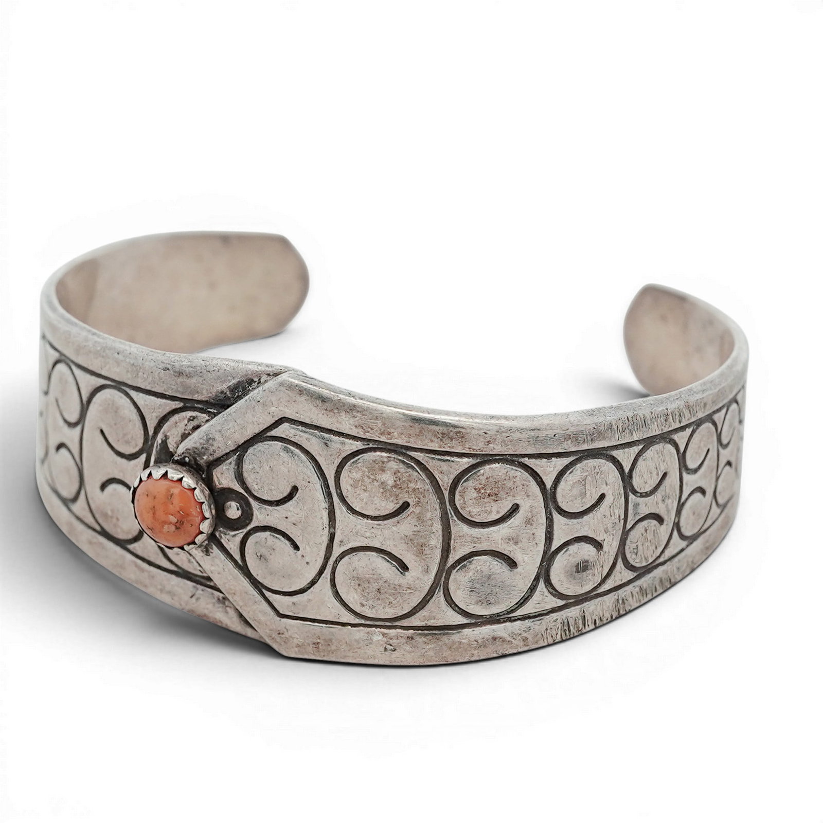 Vintage Southwestern Sterling Silver & Coral Cuff Bracelet Signed: Vintage Southwestern Sterling Silver & Coral Cuff Bracelet Signed 1970s-1980s, USA Sterling silver cuff bracelet featuring a wide band with stamped scrollwork motif and central applied geometric eleme