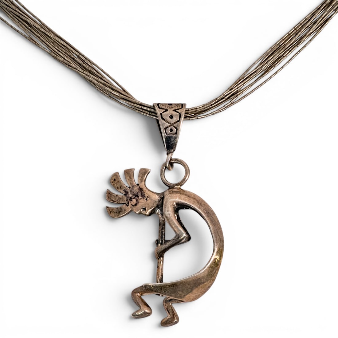 Vintage Navajo Sterling Silver Kokopelli Pendant Necklace: Vintage Navajo Sterling Silver Kokopelli Pendant Necklace 1970s-1980s, USA Sterling silver necklace featuring a cast Kokopelli figure pendant with applied bail, suspended from a multi-strand heishi be