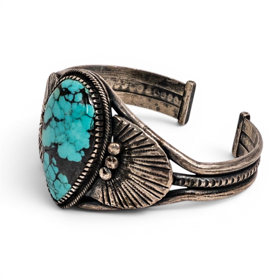 Tommy DeCorti Navajo Sterling Silver & Turquoise Cuff Bracelet: Tommy DeCorti Navajo Sterling Silver & Turquoise Cuff Bracelet 1980s–1990s, USA Navajo sterling silver cuff bracelet by Tommy DeCorti set with a large pear-shaped turquoise cabochon in a rope-twist 