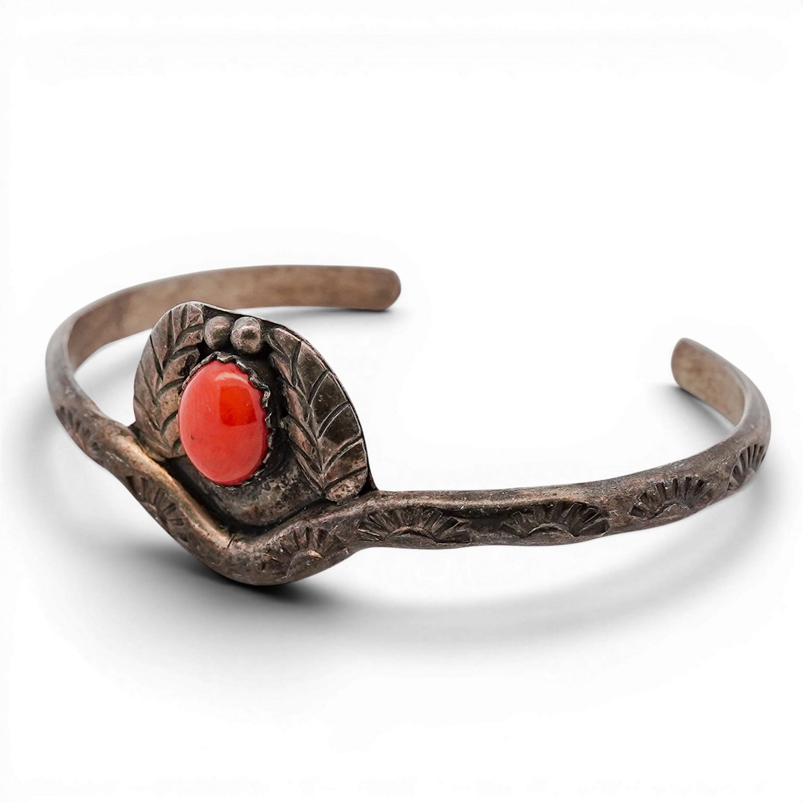 Vintage Navajo Sterling Silver & Coral Cuff Bracelet: Vintage Navajo Sterling Silver & Coral Cuff Bracelet 1970s–1980s, USA Vintage Navajo Sterling Silver cuff bracelet with a single oval cabochon red coral set in a serrated bezel. The stone is framed 