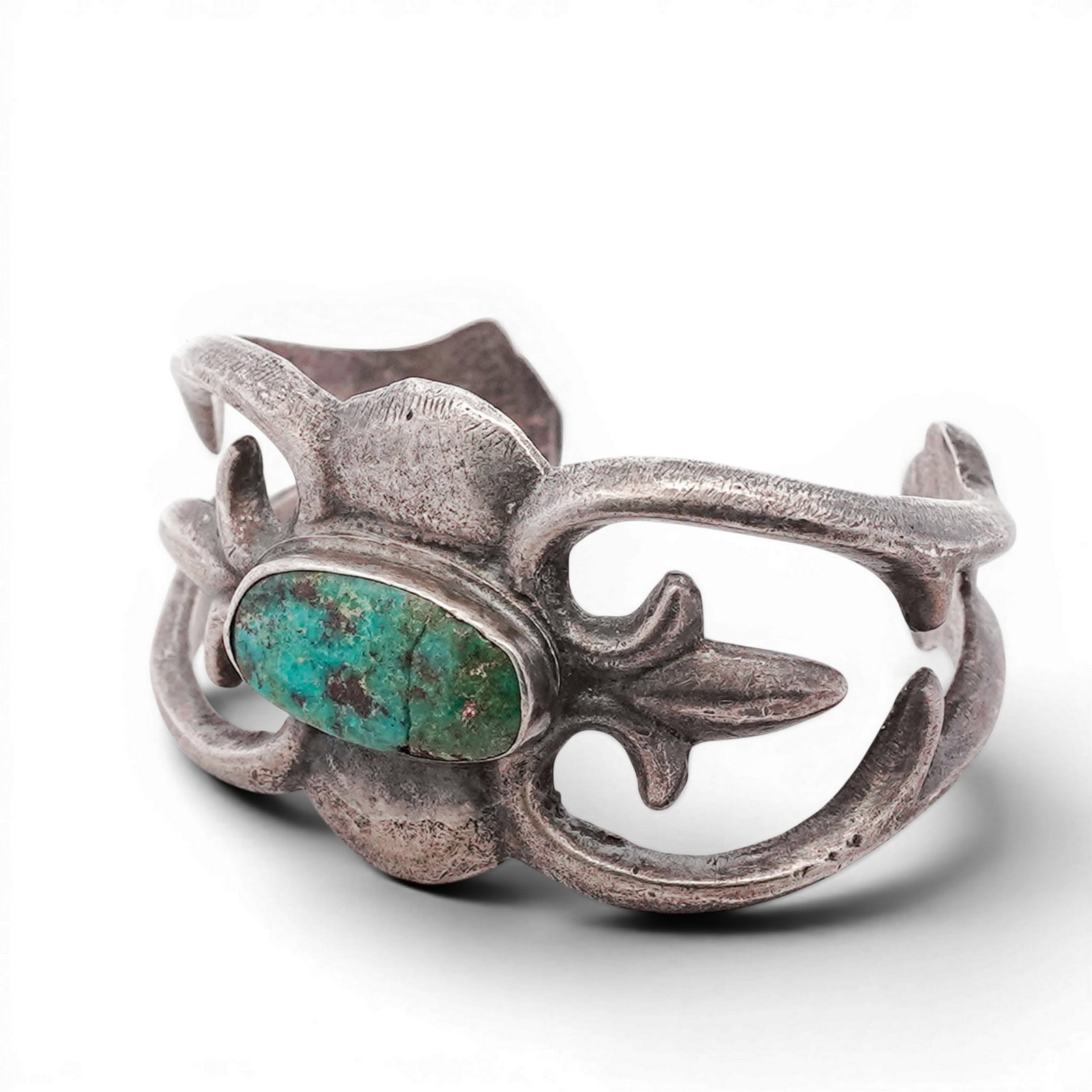 Vintage Navajo Sterling Silver & Turquoise Cuff Bracelet: Vintage Navajo Sterling Silver & Turquoise Cuff Bracelet 1970s-1980s, USA Cast and hand-finished cuff bracelet featuring a central elongated turquoise cabochon set in a plain bezel. The design incorpo