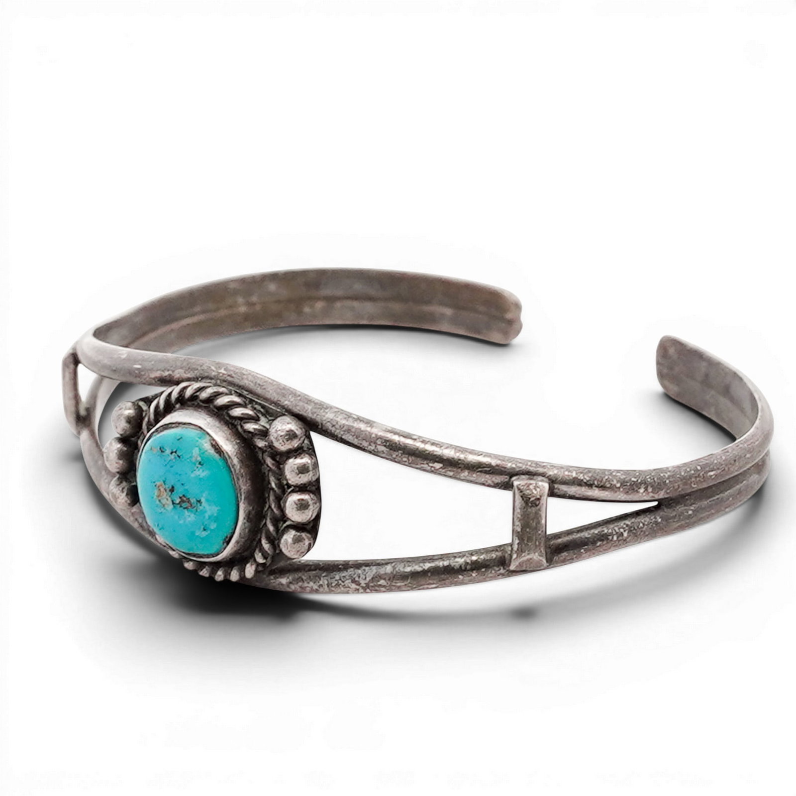 Navajo Sterling Silver & Turquoise Cuff Bracelet: Navajo Sterling Silver & Turquoise Cuff Bracelet 1970s-1980s, USA Hand-fabricated cuff bracelet featuring a central round turquoise cabochon set within a twisted rope bezel, accented by applied silver