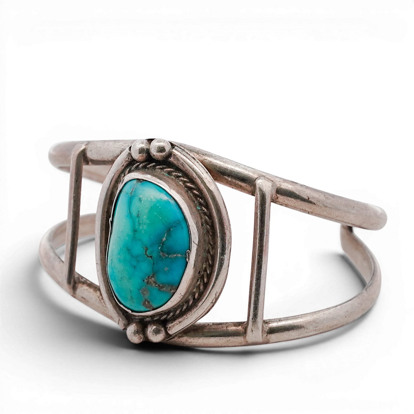 Vintage Navajo Sterling Silver & Turquoise Cuff Bracelet: Vintage Navajo Sterling Silver & Turquoise Cuff Bracelet 1970s-1980s, USA Hand-fabricated cuff bracelet centered with an oval turquoise cabochon set in a serrated bezel with rope surround. The stone i