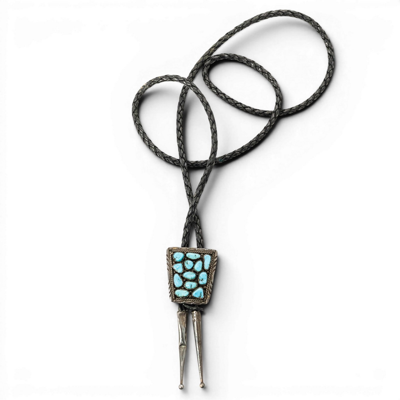 Vintage Navajo Sterling Silver & Turquoise Cluster Bolo Tie: Vintage Navajo Sterling Silver & Turquoise Cluster Bolo Tie 1970s–1980s, USA Vintage Navajo sterling silver bolo tie with rectangular slide set with twelve turquoise nugget cabochons in sawtooth bez