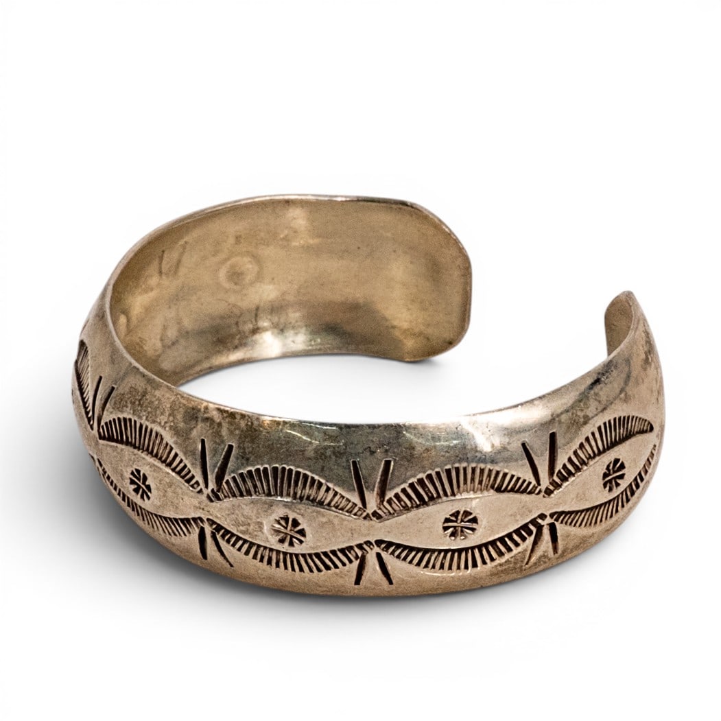 Wilbur Tracy Navajo Sterling Silver Stamped Cuff Bracelet: Wilbur Tracy Navajo Sterling Silver Stamped Cuff Bracelet 1980s–1990s, USA Navajo sterling silver cuff bracelet by Wilber Tracy, featuring traditional stamped fan, sunburst, and linear motifs