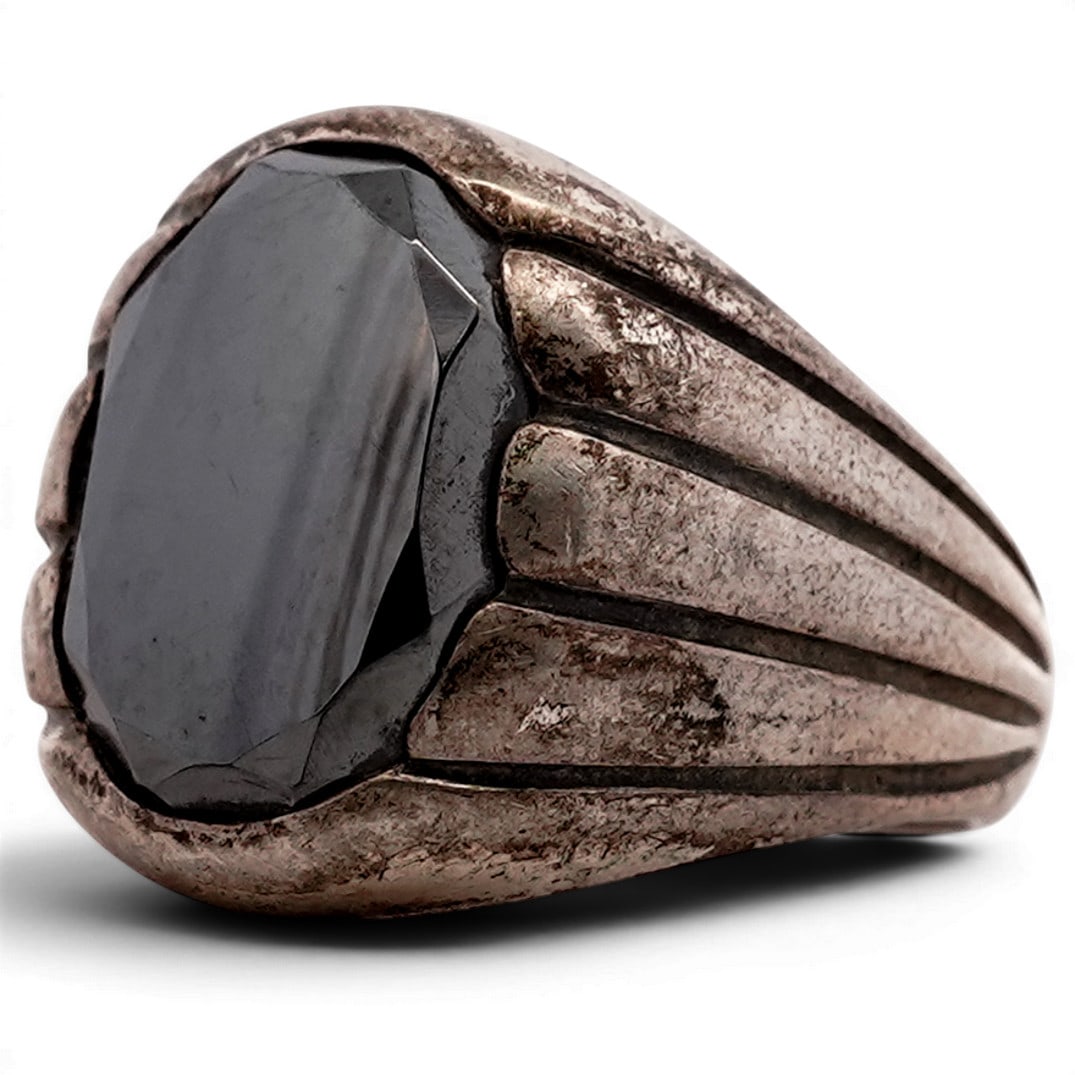 Kenneth Wayne Hematite Sterling Silver Ring: Kenneth Wayne Hematite Sterling Silver Ring 1970s-1980s, USA Sterling silver ring by Kenneth Wayne set with a large oval faceted hematite displaying strong metallic luster. The stone is mounted in a h