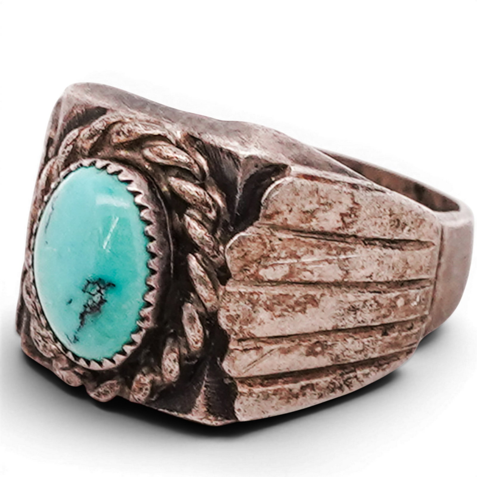Vintage Navajo Sterling Silver & Turquoise Ring: Vintage Navajo Sterling Silver & Turquoise Ring 1970s–1980s, USA Sterling silver ring set with an oval turquoise cabochon exhibiting natural matrix within a serrated bezel, surrounded by a twisted w
