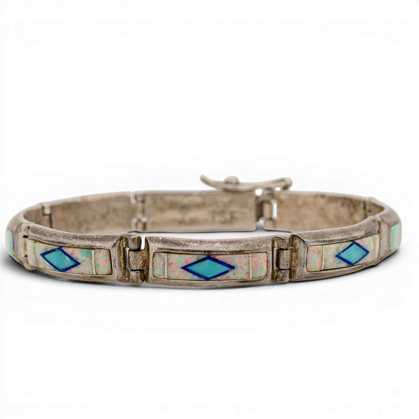 Calvin Begay Sterling Silver Inlay Link Bracelet: Calvin Begay Sterling Silver Inlay Link Bracelet 1990s-2000s, USA Sterling silver link bracelet by Calvin Begay composed of rectangular panels with geometric inlay, including opal and turquoise with