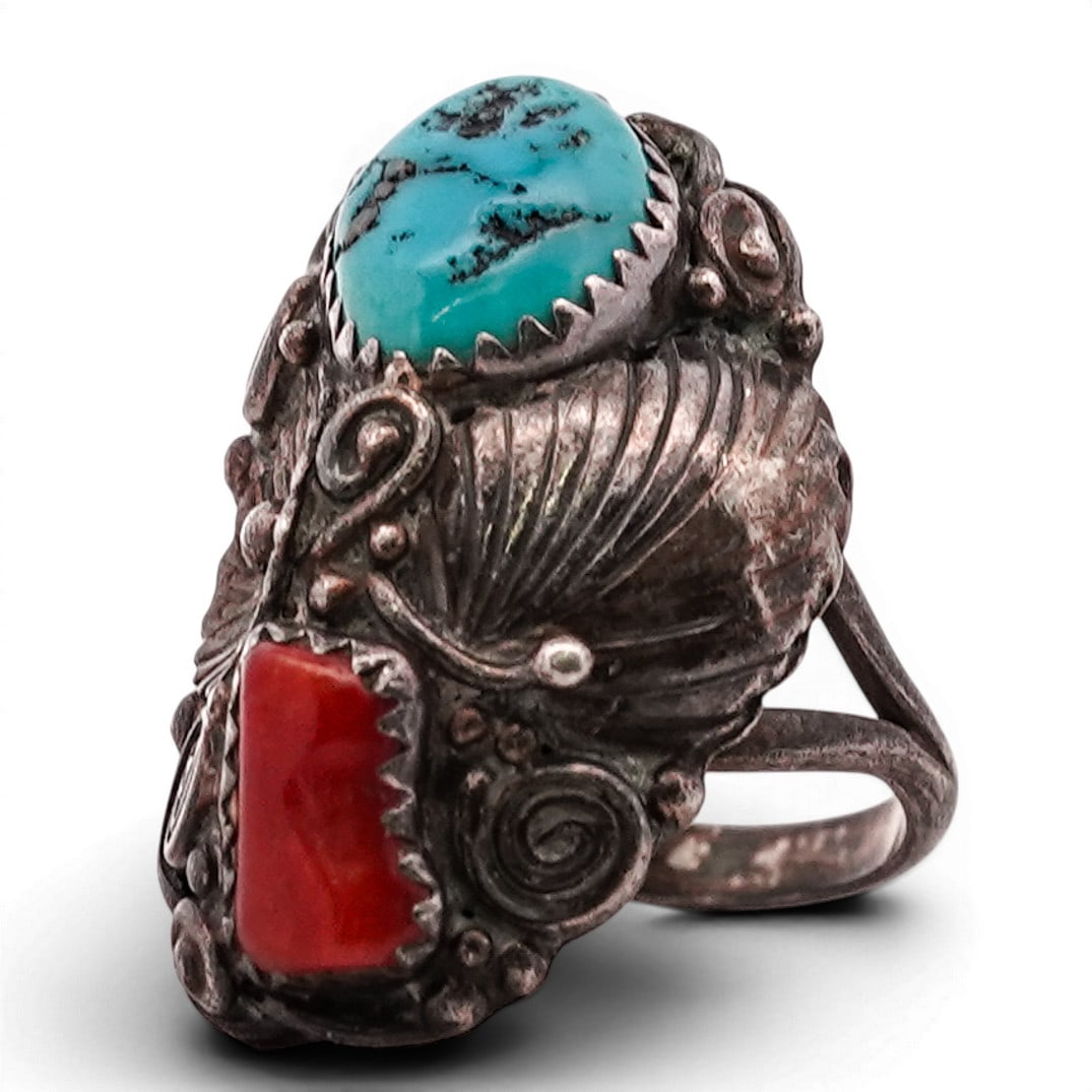 Vintage Navajo Sterling Silver Turquoise & Coral Ring: Vintage Navajo Sterling Silver Turquoise & Coral Ring 1970s–1980s, USA Sterling silver ring set with opposing turquoise and coral cabochons in serrated bezels, surrounded by applied wirework, spiral
