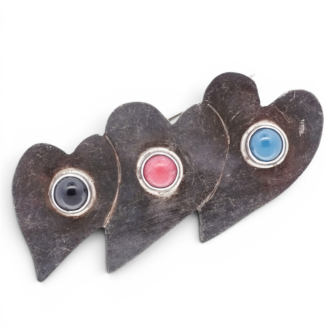 Southwestern Sterling Silver Onyx Coral & Turquoise Triple Heart Brooch Signed: Southwestern Sterling Silver Onyx Coral & Turquoise Triple Heart Brooch Signed Late 20th Century, USA Sterling silver brooch formed as three overlapping heart motifs, each set with a round cabochon in