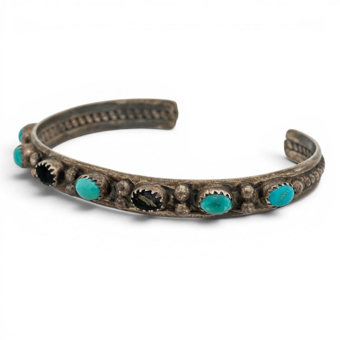 Vintage Jerry Cowboy Navajo Sterling Silver Turquoise Bracelet: Vintage Jerry Cowboy Navajo Sterling Silver Turquoise Bracelet 1970s-1980s, USA Hand-fabricated sterling silver cuff bracelet set with alternating oval turquoise cabochons in serrated bezels, interspe