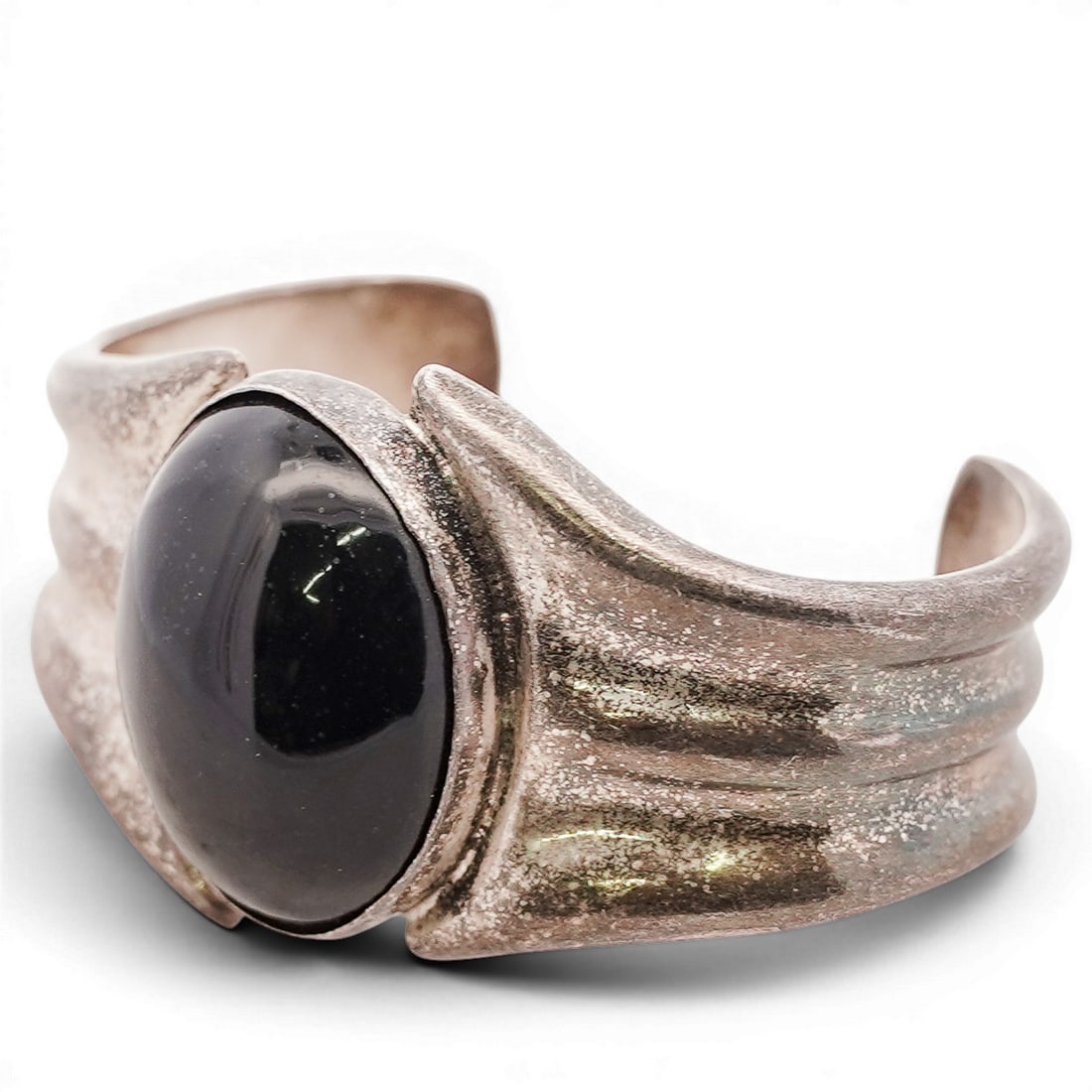 House of Bangles Sterling Silver & Black Onyx Cuff Bracelet: House of Bangles Sterling Silver & Black Onyx Cuff Bracelet 1980s-2000s, Mexican Sterling silver cuff bracelet by House of Bangles, centered by a large black onyx cabochon, set within a wide sculptura