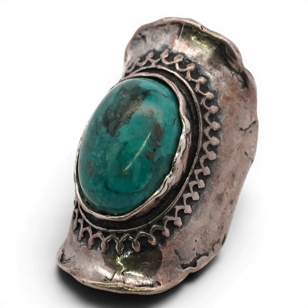 Israeli Sterling Silver & Turquoise Ring Signed: Israeli Sterling Silver & Turquoise Ring Signed Late 20th Century, Israeli Sterling silver ring set with an oval turquoise cabochon displaying blue-green coloration with natural brown matrix. The ston