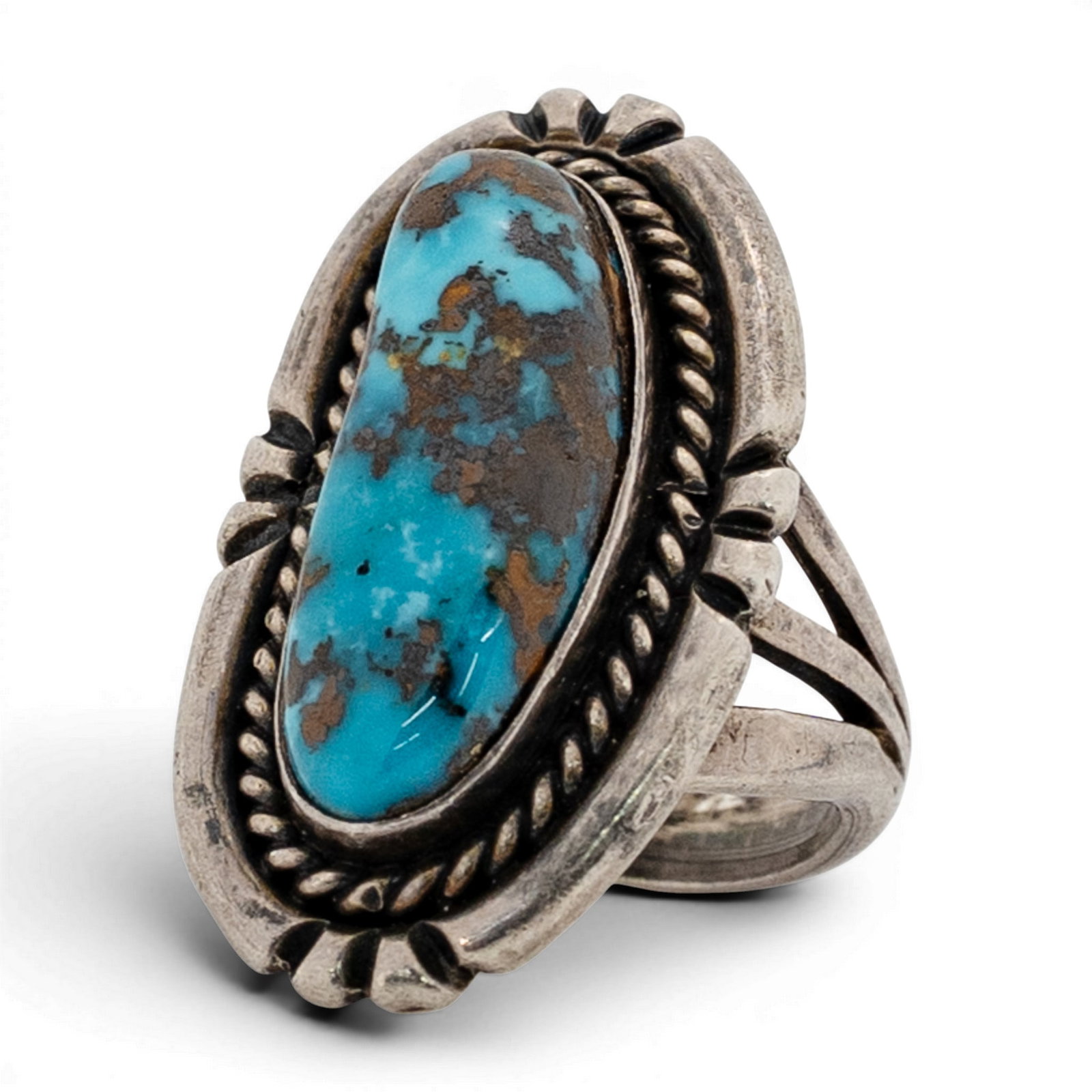 Vintage Les Hill Navajo Sterling Silver & Turquoise Ring: Vintage Les Hill Navajo Sterling Silver & Turquoise Ring 1970s-1980s, USA Elongated oval turquoise cabochon with brown matrix set in a serrated bezel, framed by twisted wire rope border within an open