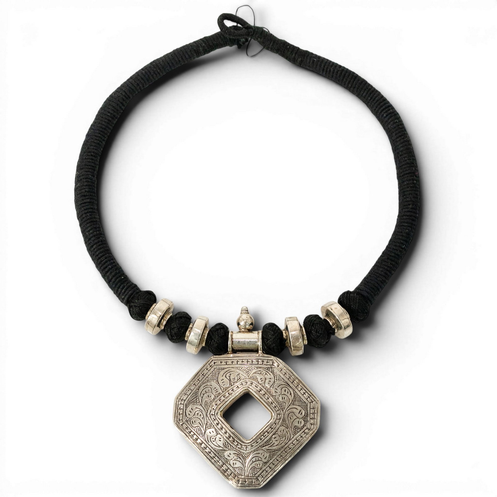 Sterling Silver Repousse Pendant Cord Necklace: Sterling Silver Repousse Pendant Cord Necklace Late 20th Century Sterling silver cord necklace featuring a black wrapped cord with sterling silver bead accents and a large octagonal repoussé pendant.