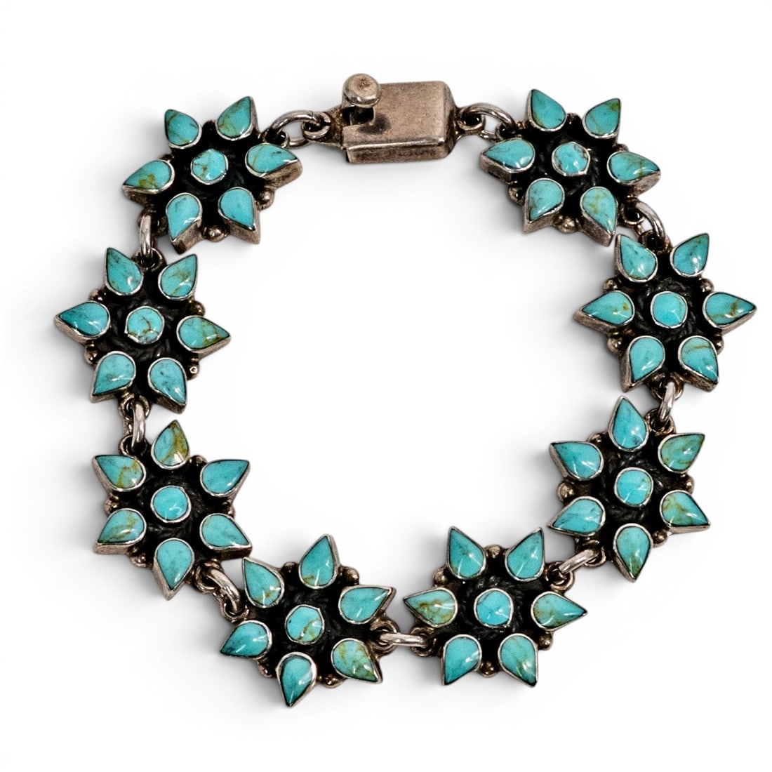 Navajo Sterling Silver & Turquoise Cluster Link Bracelet: Navajo Sterling Silver & Turquoise Cluster Link Bracelet 1980s–1990s, USA Navajo sterling silver link bracelet featuring a series of connected floral cluster panels, each set with pear-shaped and ro