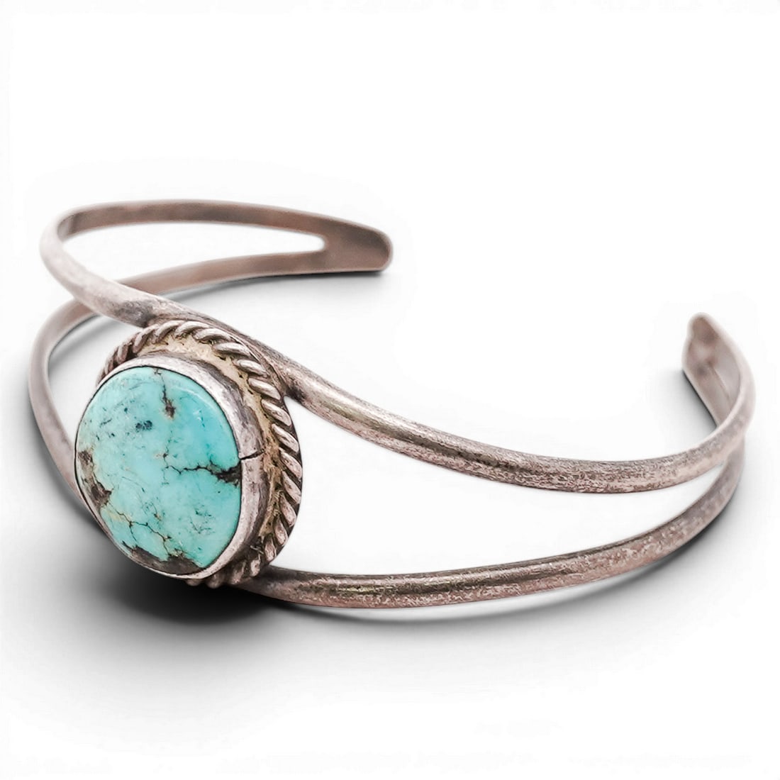 Vintage Navajo Sterling Silver & Turquoise Cuff Bracelet: Vintage Navajo Sterling Silver & Turquoise Cuff Bracelet 1970s-1980s, USA Vintage Navajo sterling silver cuff set with a round turquoise cabochon in a rope-twist bezel on a double-band shank. Tested s