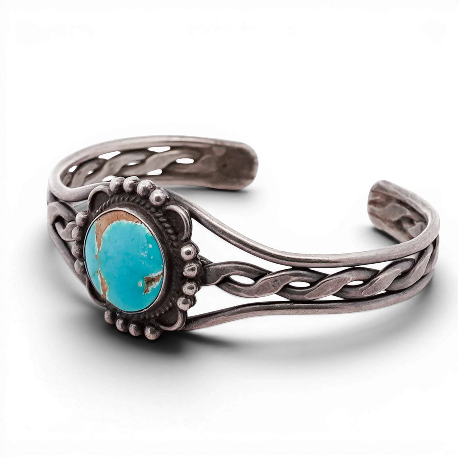 Vintage Navajo Sterling Silver & Turquoise Cuff Bracelet: Vintage Navajo Sterling Silver & Turquoise Cuff Bracelet 1970s-1980s, USA Hand-fabricated cuff bracelet centered with a round turquoise cabochon set in a serrated bezel, surrounded by applied silver b
