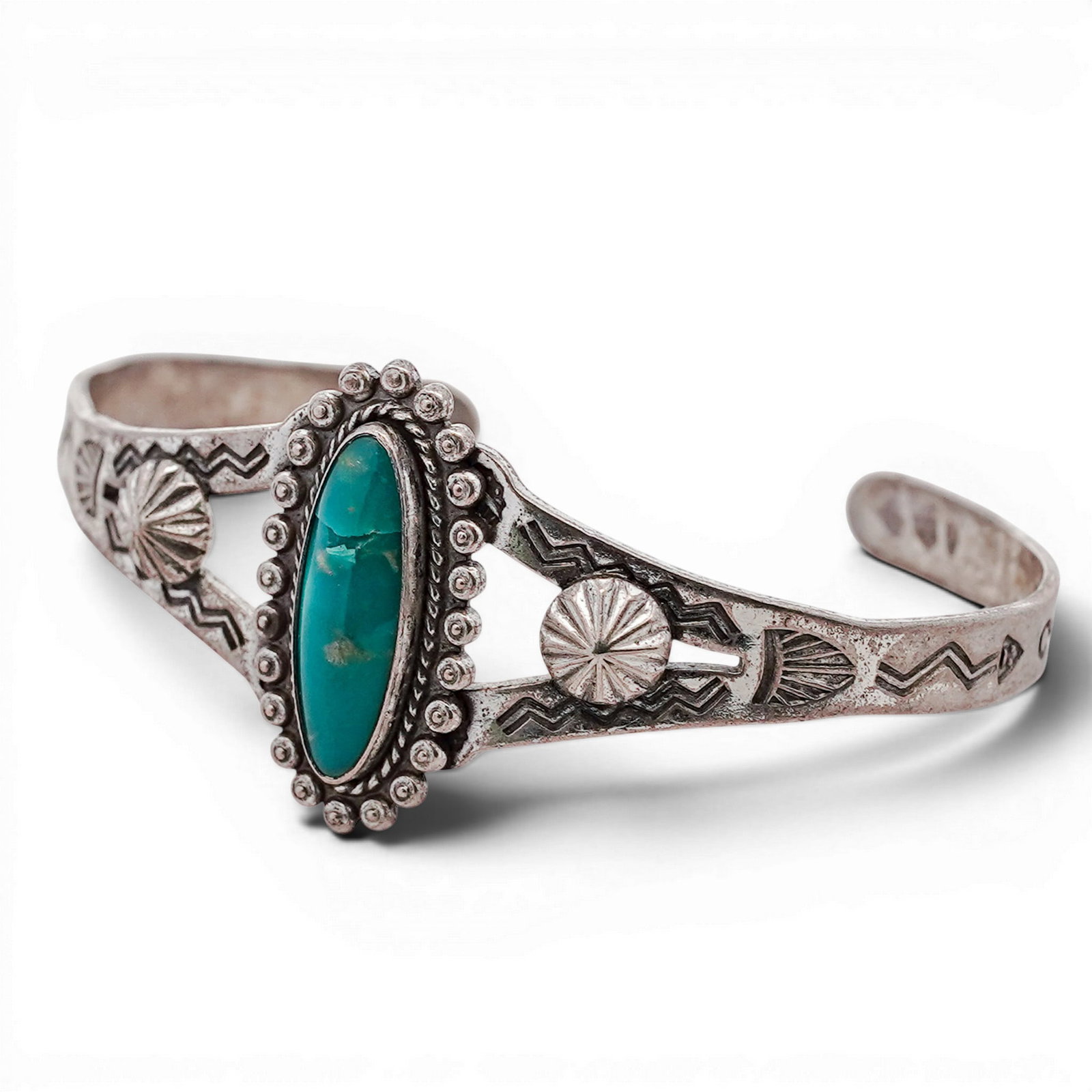 Vintage Navajo Sterling Silver & Turquoise Cuff Bracelet: Vintage Navajo Sterling Silver & Turquoise Cuff Bracelet 1970s-1980s, USA Hand-stamped cuff bracelet centered with a marquise-shaped turquoise cabochon set in a serrated bezel, surrounded by applied s