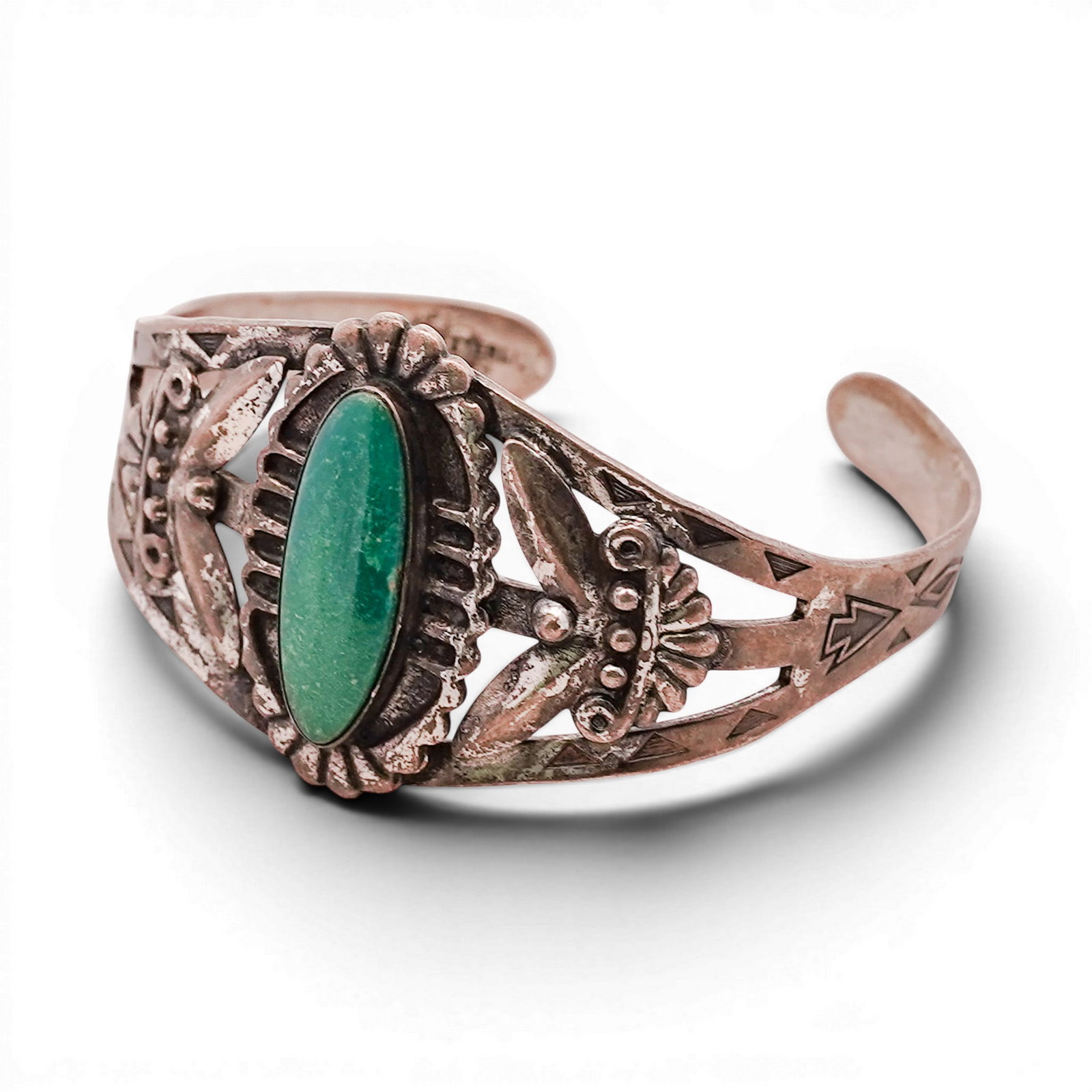 Vintage Navajo Sterling Silver & Green Turquoise Cuff Bracelet: Vintage Navajo Sterling Silver & Green Turquoise Cuff Bracelet 1970s-1980s, USA Sterling silver cuff centered with an elongated oval green turquoise cabochon in a serrated bezel, framed by radiating s