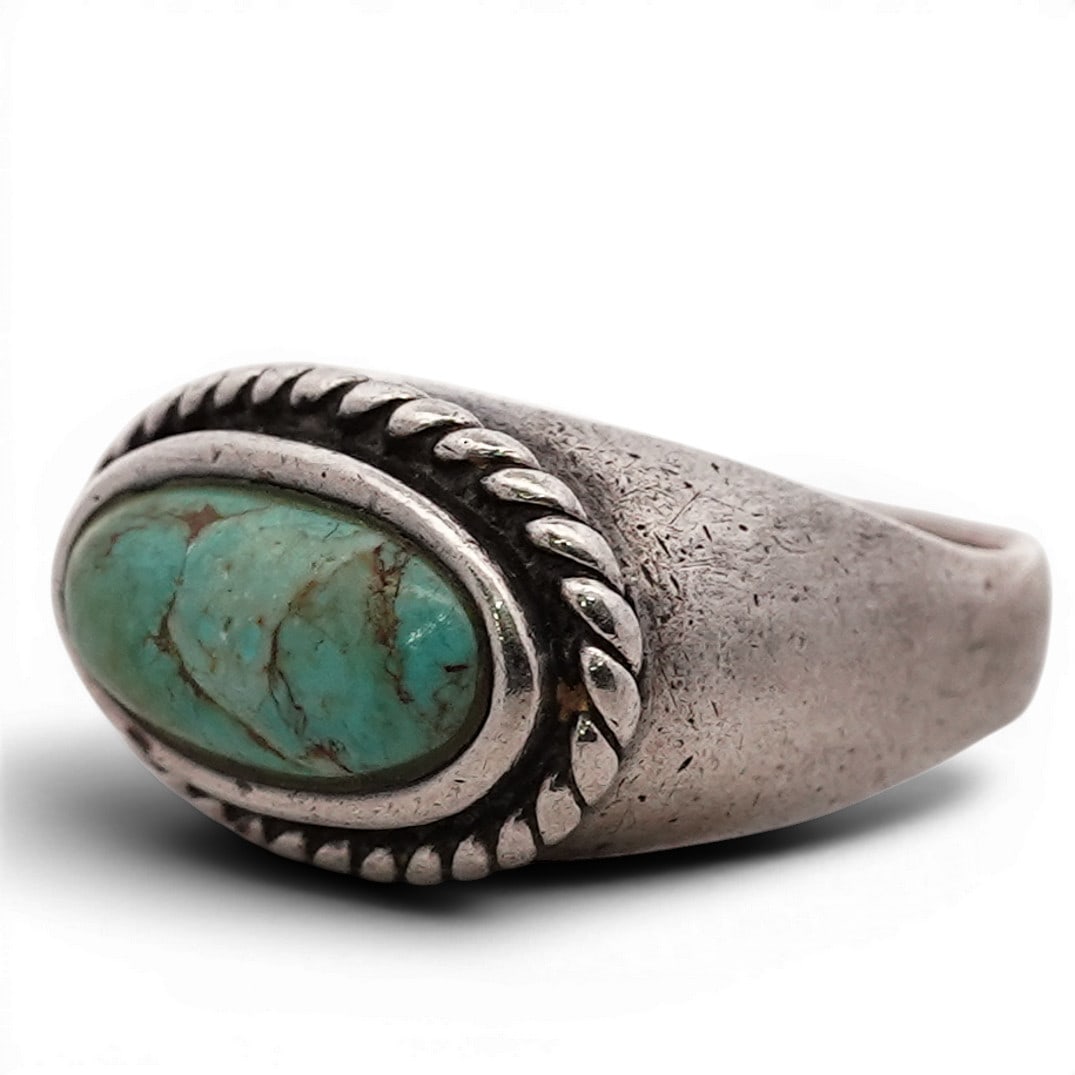 Barse Sterling Silver & Turquoise Ring: Barse Sterling Silver & Turquoise Ring 1990s-2000s, Chinese Sterling silver ring by Barse set with an oval green turquoise cabochon displaying natural matrix. The stone is mounted in a smooth bezel an