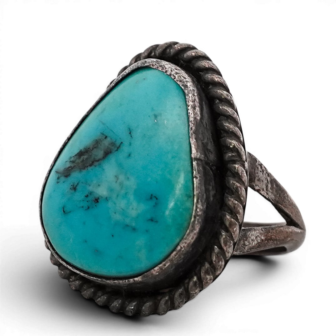 Vintage Navajo Sterling Silver & Turquoise Ring with Twisted Rope Border: Vintage Navajo Sterling Silver & Turquoise Ring with Twisted Rope Border 1970s-1980s, USA Vintage Navajo sterling silver ring set with a cabochon turquoise stone displaying light blue coloration with 