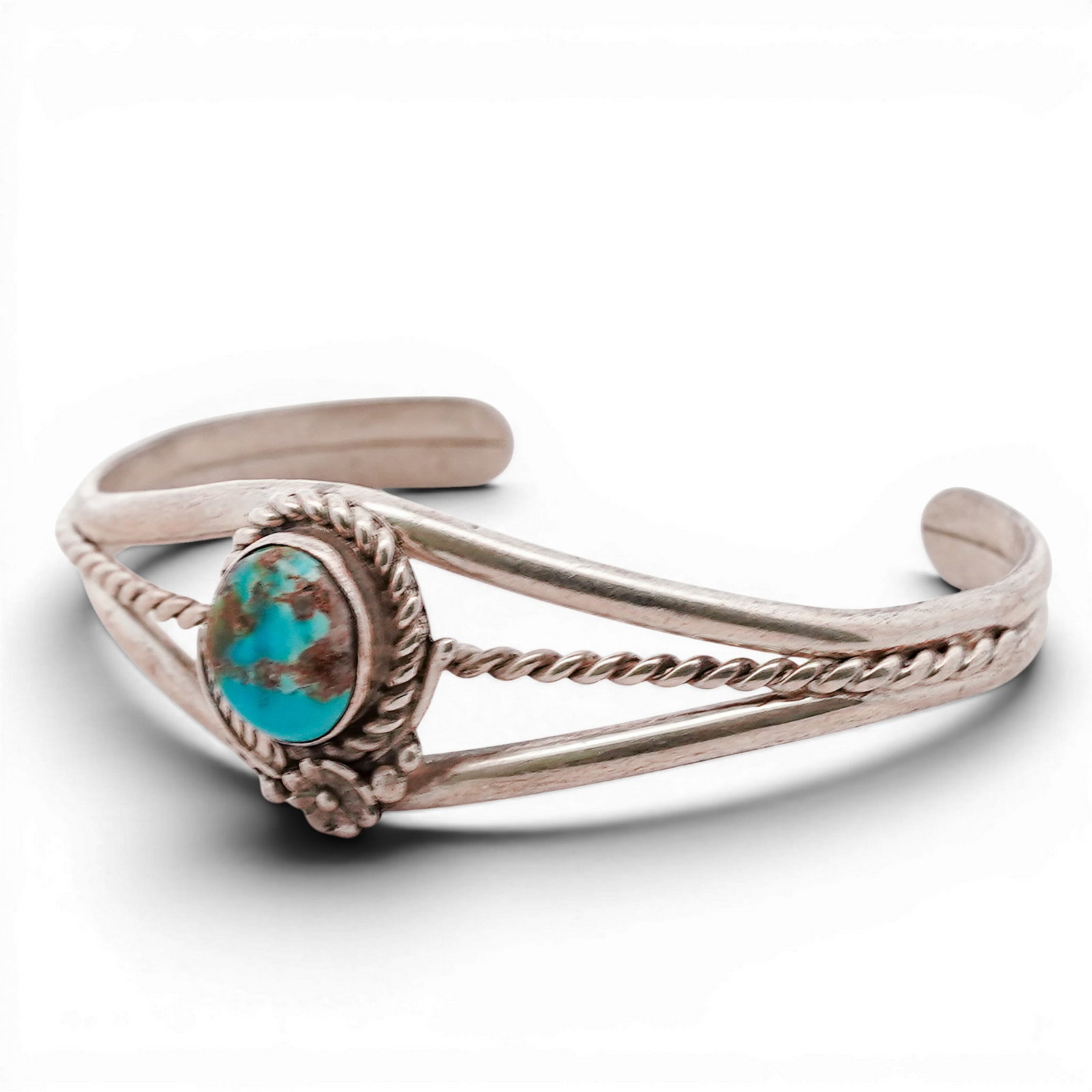 Vintage Navajo Sterling Silver & Turquoise Cuff Bracelet: Vintage Navajo Sterling Silver & Turquoise Cuff Bracelet 1970s-1980s, USA Hand-fabricated cuff bracelet centered by an oval turquoise cabochon set in a rope-twist bezel with applied bead accents. The 