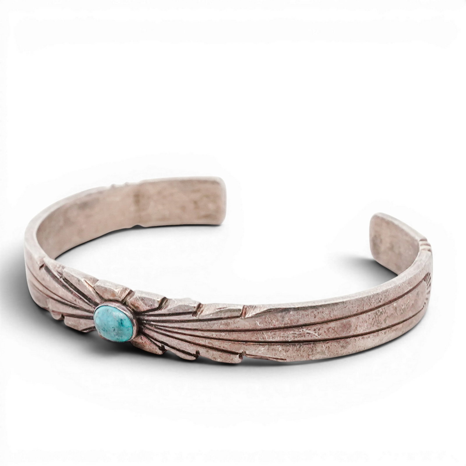 Vintage Navajo Sterling Silver & Turquoise Cuff Bracelet Signed: Vintage Navajo Sterling Silver & Turquoise Cuff Bracelet Signed 1970s-1980s, USA Sterling silver cuff set with an oval turquoise cabochon in bezel setting, with radiating repoussé elements. Interior 