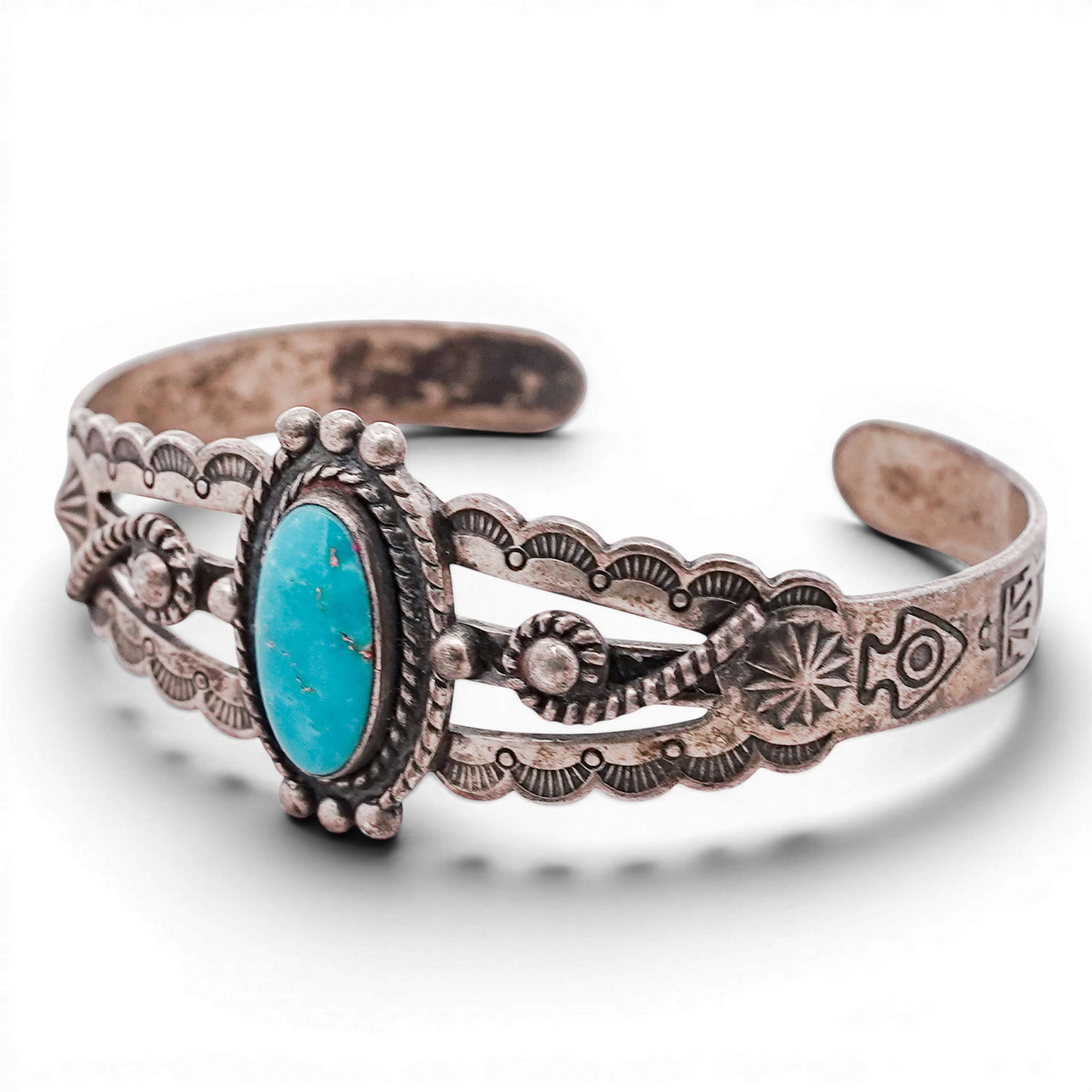 Vintage Navajo Sterling Silver & Turquoise Cuff Bracelet: Vintage Navajo Sterling Silver & Turquoise Cuff Bracelet 1970s-1980s, USA Hand-fabricated cuff bracelet centered by an oval turquoise cabochon in a rope-twist bezel, flanked by applied bead and wire e