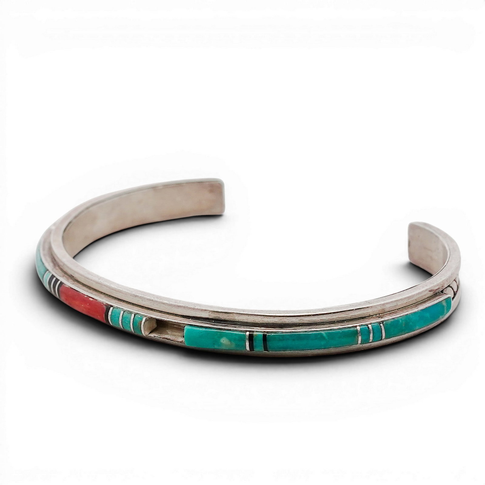 Vintage Adeline Zuni Sterling Silver & Multi-Stone Inlay Cuff Bracelet: Vintage Adeline Zuni Sterling Silver & Multi-Stone Inlay Cuff Bracelet 1990s-2000s, USA Sterling silver cuff with a continuous channel inlay of turquoise, coral, jet, and shell, arranged in linear geo
