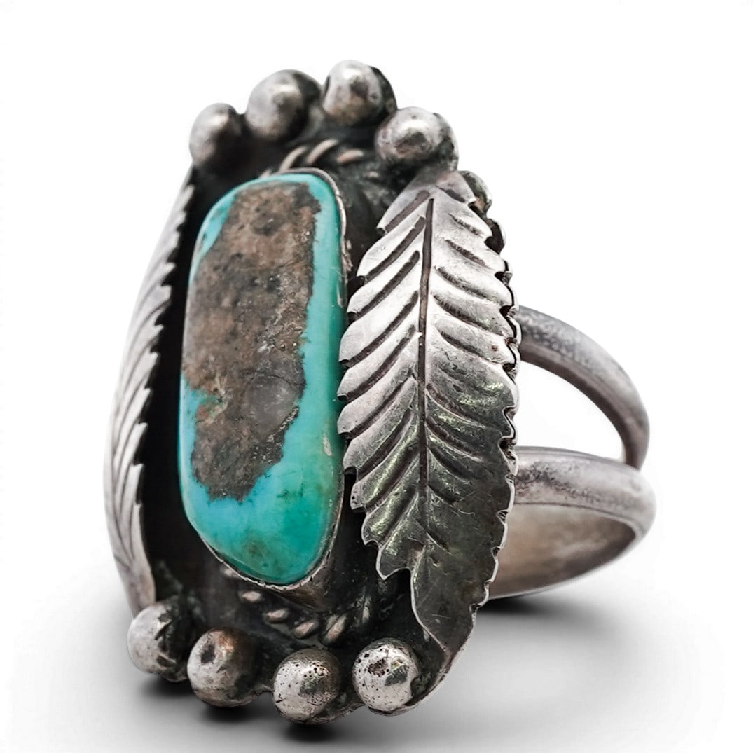 Vintage Navajo Sterling Silver & Turquoise Ring: Vintage Navajo Sterling Silver & Turquoise Ring 1970s-1980s, USA Vintage oval ring set with a natural turquoise cabochon exhibiting blue-green coloration with substantial brown matrix, framed by twist