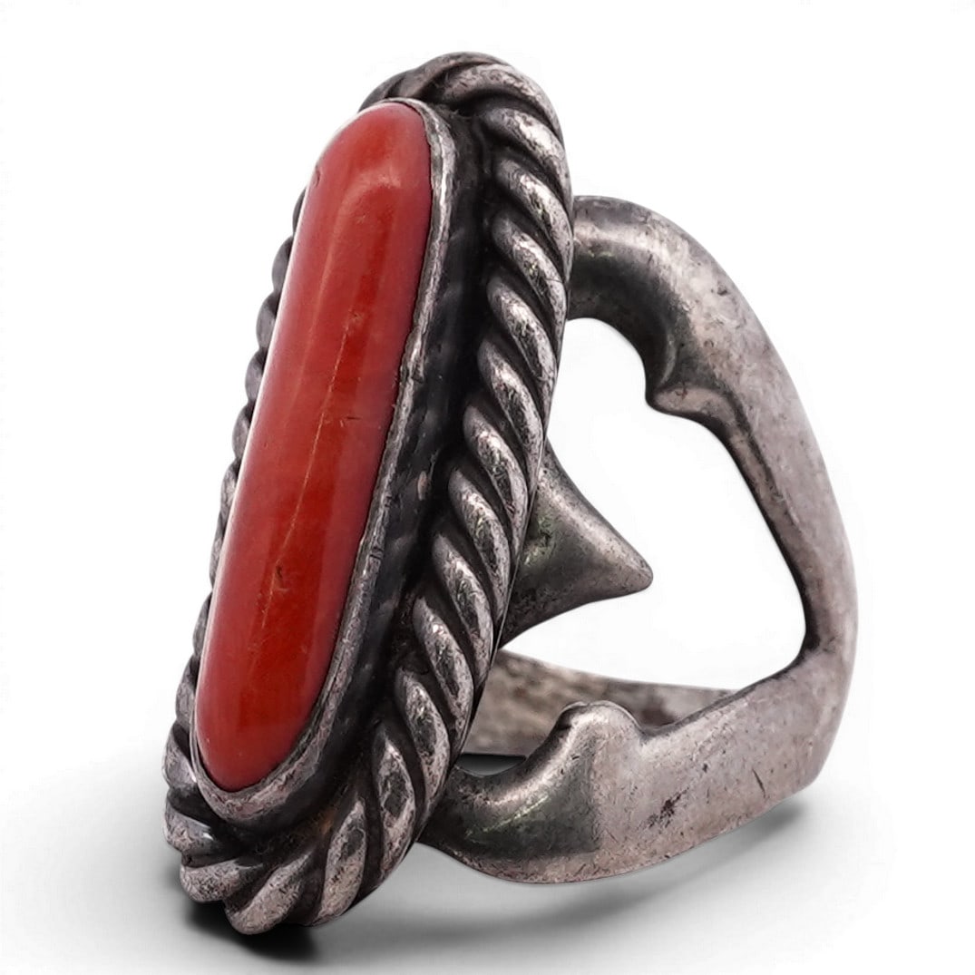 Vintage Navajo Sterling Silver & Coral Ring: Vintage Navajo Sterling Silver & Coral Ring 1970s-1980s, USA Vintage Navajo ring set with an elongated coral cabochon in a serrated bezel, framed by a twisted rope border, the mount supported by a dis
