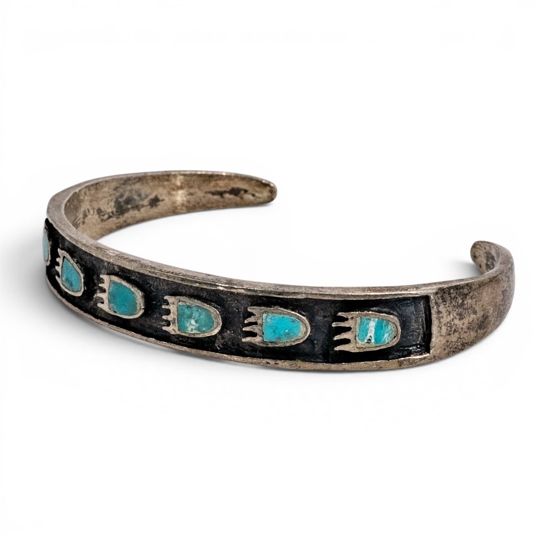 Vintage Navajo Sterling Silver & Turquoise Paw Inlay Cuff Bracelet: Vintage Navajo Sterling Silver & Turquoise Paw Inlay Cuff Bracelet Late 20th century, USA Vintage Navajo sterling silver cuff bracelet with a darkened channel design set with repeated turquoise inlay 