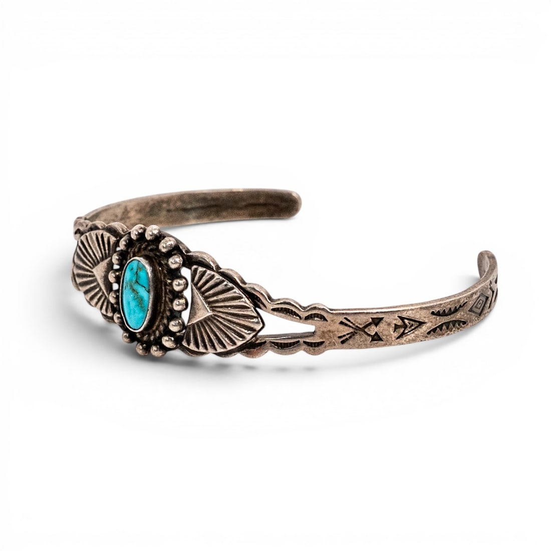 Vintage Navajo Sterling Silver & Turquoise Cuff Bracelet: Vintage Navajo Sterling Silver & Turquoise Cuff Bracelet Late 20th century, USA Vintage Navajo sterling silver cuff bracelet centered by an oval turquoise cabochon in a serrated bezel, framed by appli