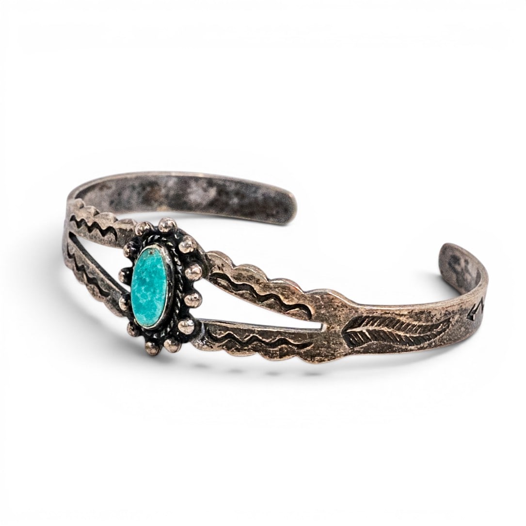 Vintage Navajo Sterling Silver & Turquoise Cuff Bracelet: Vintage Navajo Sterling Silver & Turquoise Cuff Bracelet 1970s–1980s, USA Navajo sterling silver cuff bracelet with split-shank construction centered by an oval turquoise cabochon in a raised bezel,