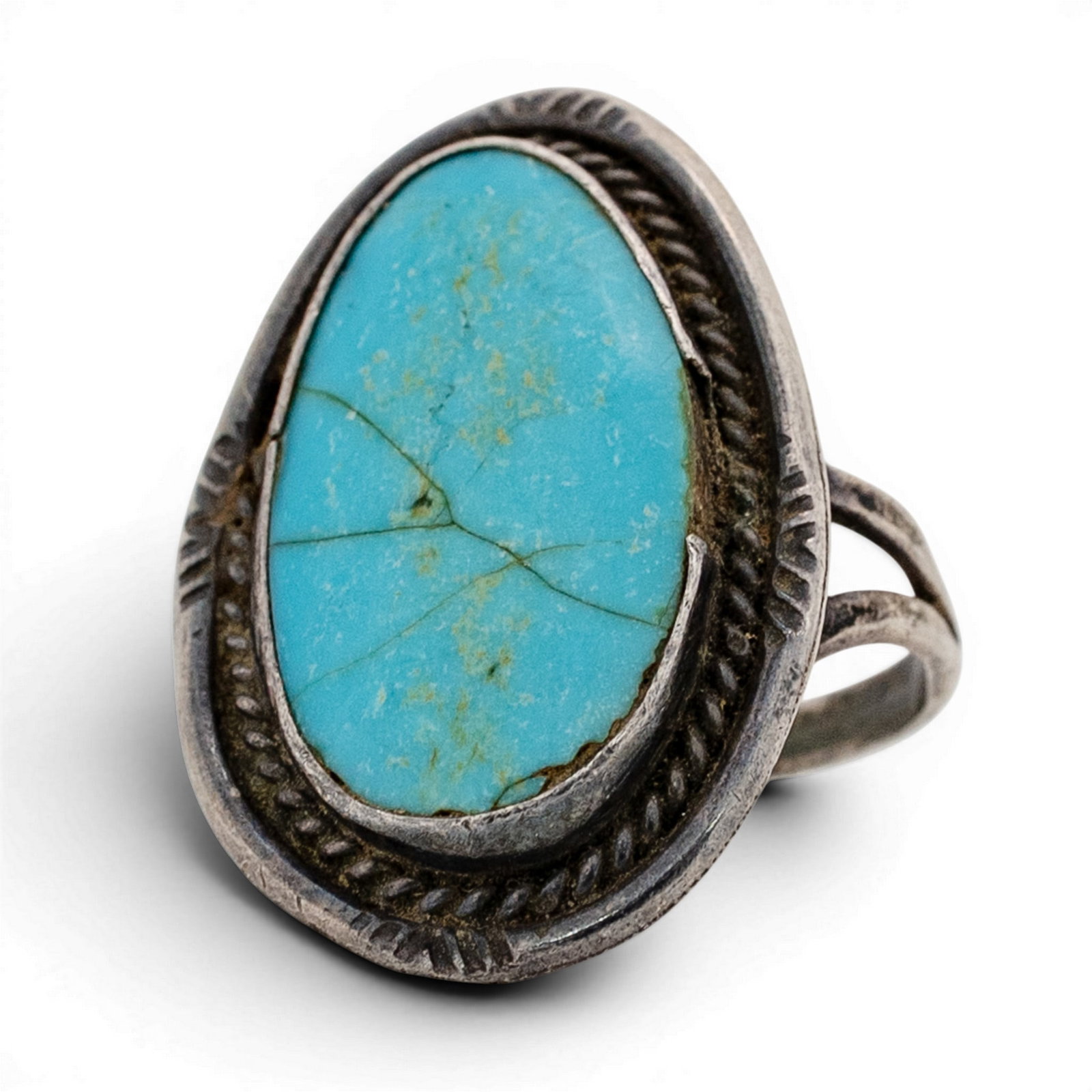 Vintage Navajo Sterling Silver & Turquoise Ring: Vintage Navajo Sterling Silver & Turquoise Ring 1970s-1980s, USA Large oval turquoise cabochon with light matrix veining, set in a plain bezel and framed by a stamped oval surround with inner twisted 