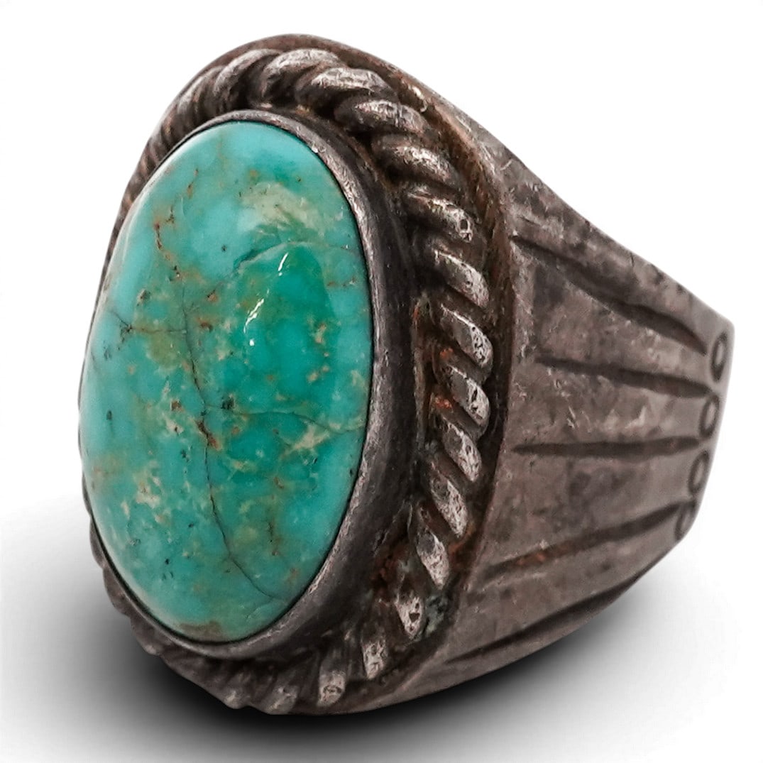Vintage Navajo Sterling Silver & Turquoise Oval Ring: Vintage Navajo Sterling Silver & Turquoise Oval Ring 1970s-1980s, USA Heavy sterling silver ring set with a large oval turquoise cabochon displaying blue-green coloration with natural golden-brown mat