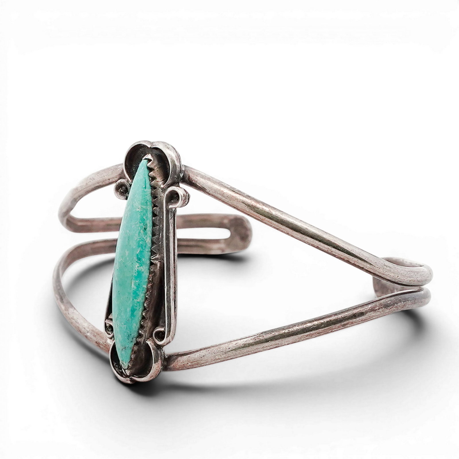 Vintage Navajo Sterling Silver & Turquoise Cuff Bracelet: Vintage Navajo Sterling Silver & Turquoise Cuff Bracelet 1960s-1970s, USA Sterling silver cuff centered with a long navette turquoise cabochon in a serrated bezel, framed by applied wire scrollwork an