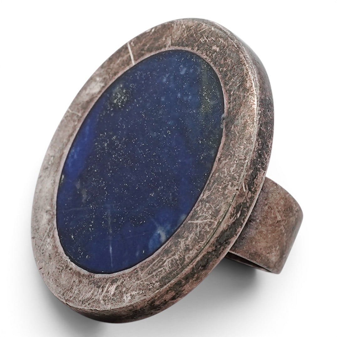 Vintage Sterling Silver & Lapis Lazuli Ring: Vintage Sterling Silver & Lapis Lazuli Ring 1970s-1980s Sterling silver ring set with a large oval lapis lazuli cabochon within a plain bezel. The mount features a wide, smooth silver surround with a 