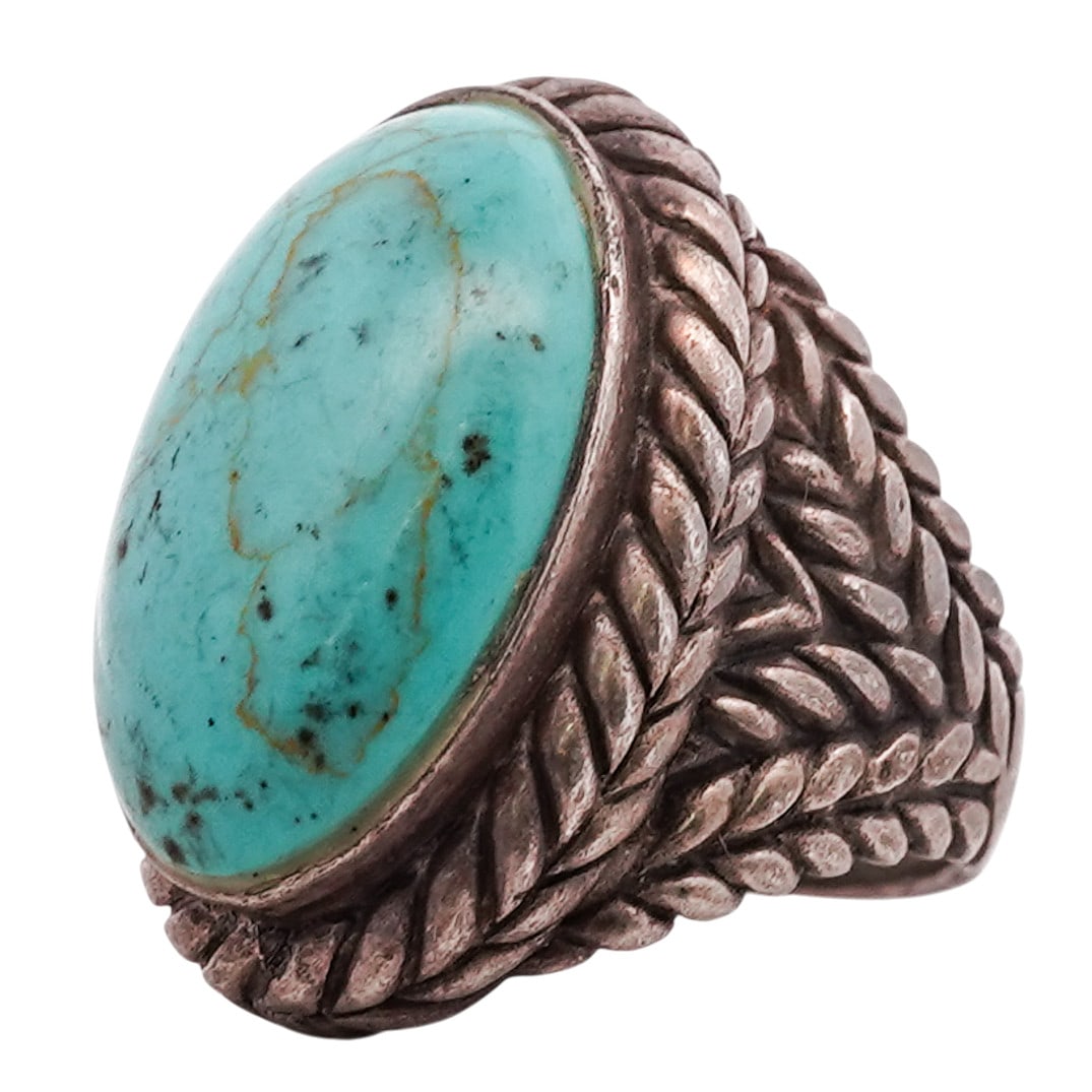 Vintage Navajo Sterling Silver & Turquoise Ring: Vintage Navajo Sterling Silver & Turquoise Ring 1970s–1980s, USA Sterling silver ring set with a large oval turquoise cabochon in a plain bezel, surrounded by a heavy twisted rope border. The mount 