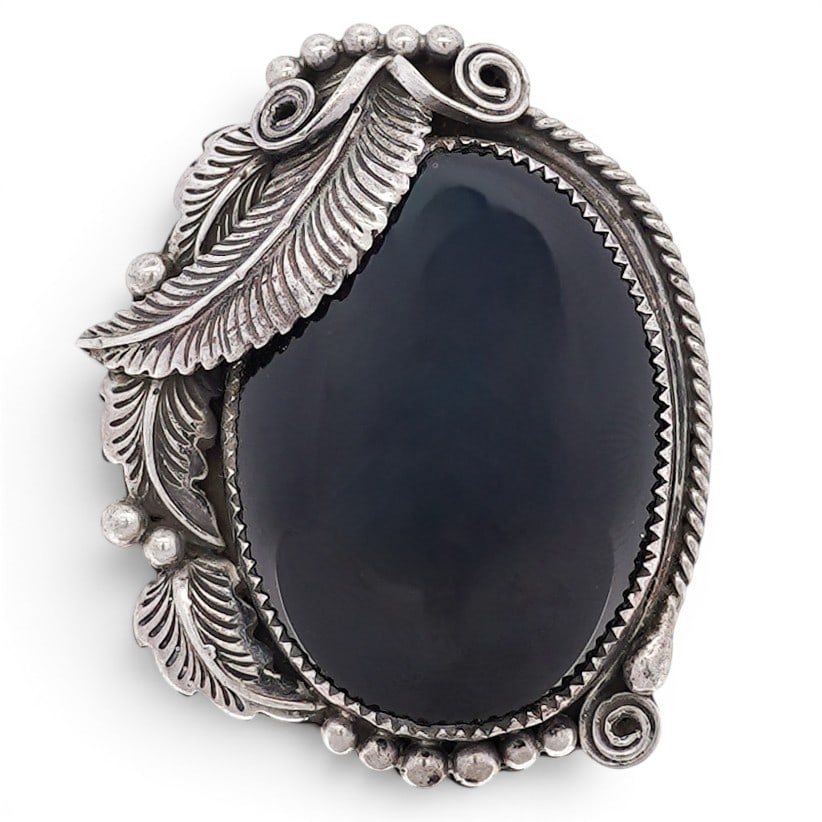 Vintage Navajo Sterling Silver & Black Onyx Pendant Brooch Signed: Vintage Navajo Sterling Silver & Black Onyx Pendant Brooch Signed 1970s–1980s, USA Sterling silver brooch pendant set with a large oval black onyx cabochon within a serrated bezel. The mount is acce