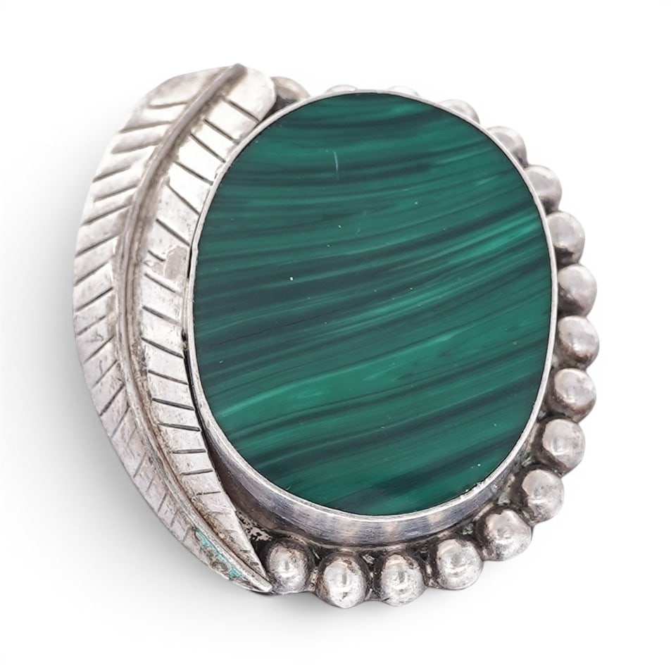 Vintage Mexican Sterling Silver & Malachite Brooch: Vintage Mexican Sterling Silver & Malachite Brooch 1970s-1980s, Mexican Vintage Mexican sterling silver brooch centered by a large oval malachite cabochon displaying vivid green banding, set in a plai