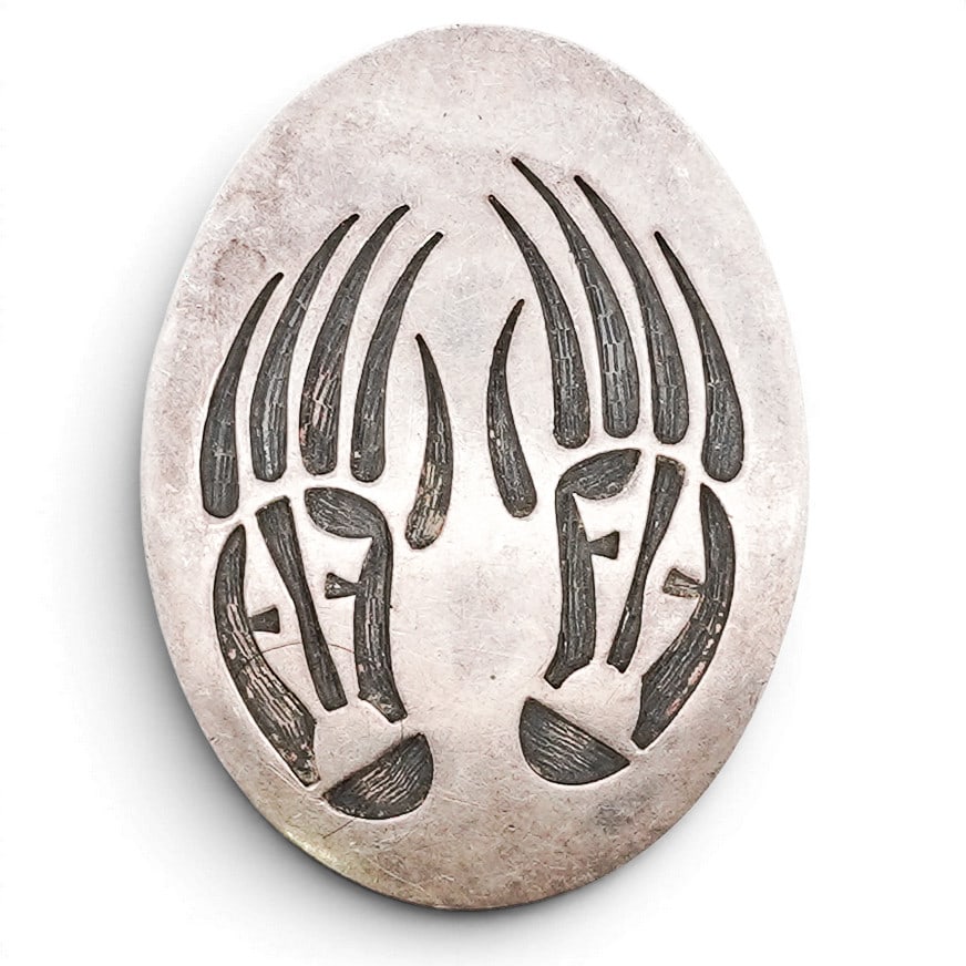 Vintage Southwestern Sterling Silver Bear Paw Overlay Belt Buckle: Vintage Southwestern Sterling Silver Bear Paw Overlay Belt Buckle 1970s-1980s, USA Sterling silver belt buckle of oval form with pierced bear motif design, the figures rendered in a mirrored compositi
