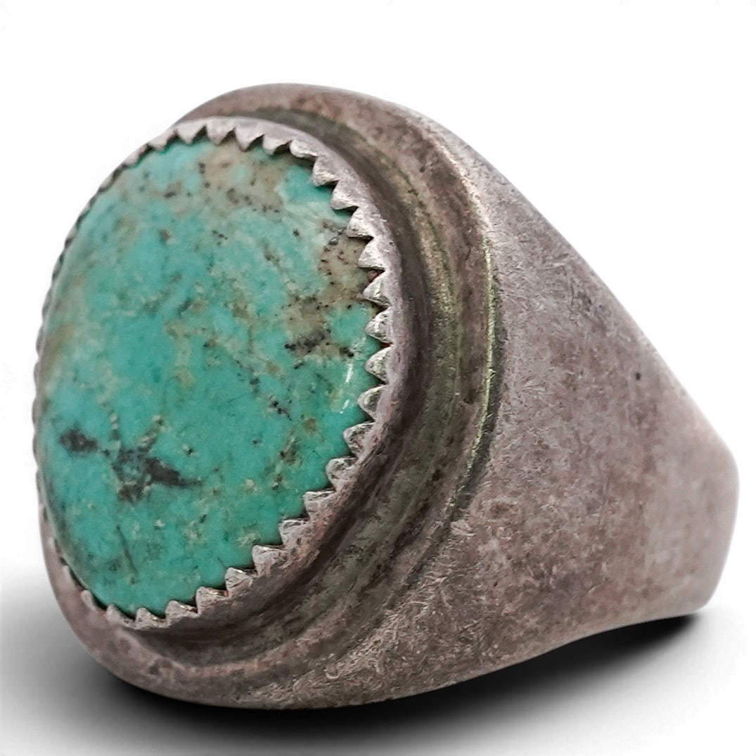 Vintage Navajo Sterling Silver & Turquoise Ring: Vintage Navajo Sterling Silver & Turquoise Ring 1970s-1980s, USA Silver ring set with a large semi-round turquoise cabochon displaying blue-green coloration with natural brown matrix. The stone is mou