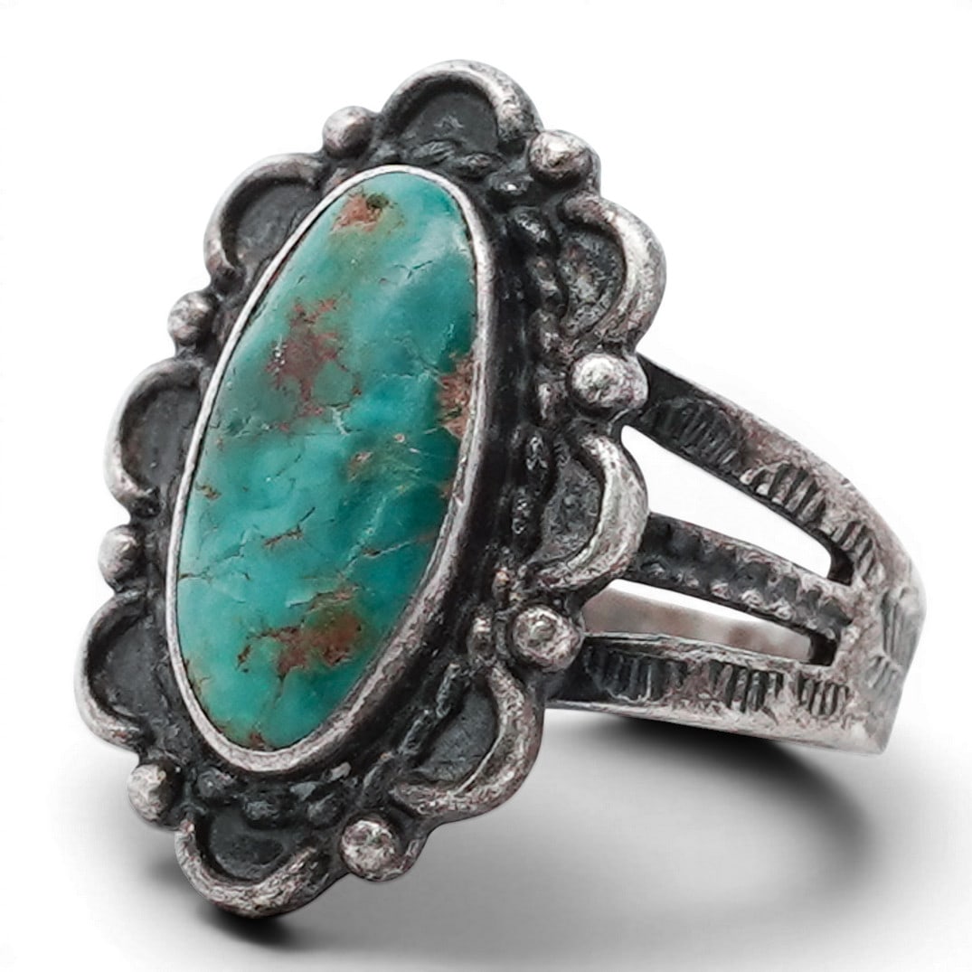 Vintage Navajo Sterling Silver & Turquoise Scalloped Ring: Vintage Navajo Sterling Silver & Turquoise Scalloped Ring 1970s-1980s, USA Silver ring featuring an oval turquoise cabochon displaying green coloration with warm golden-brown matrix. The stone is