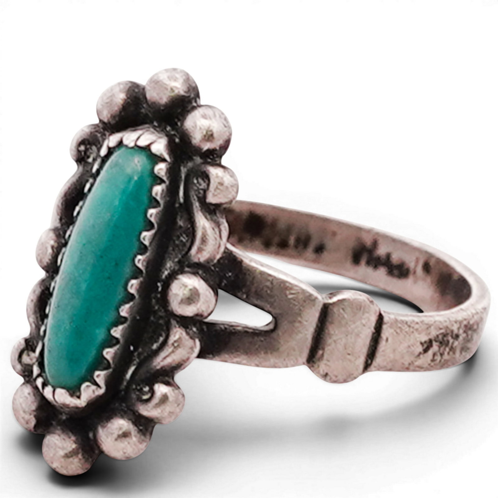 Vintage Navajo Sterling Silver & Turquoise Ring: Vintage Navajo Sterling Silver & Turquoise Ring 1970s-1980s, USA Sterling silver ring set with a narrow oval turquoise cabochon within a serrated bezel, surrounded by applied bead accents. The mount f