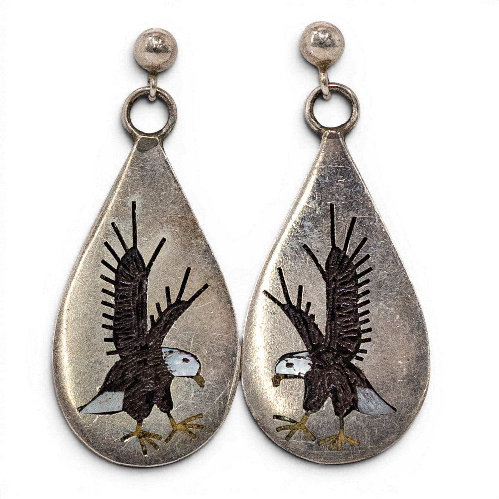 Lotti Sterling Silver Eagle Overlay Earrings: Lotti Sterling Silver Eagle Overlay Earrings 1980s-1990s, USA Pair of sterling silver teardrop-form pendant earrings with overlay eagle motifs accented with brass talons and mother-of-pearl inlay to t